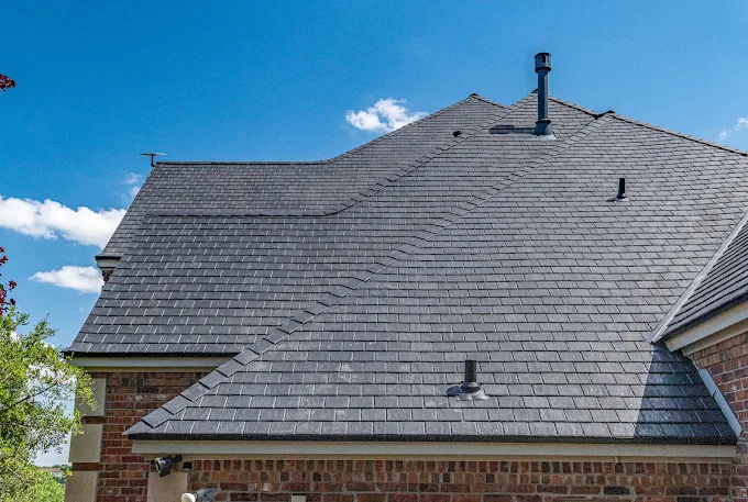 New dark gray architectural shingle roof on a brick home